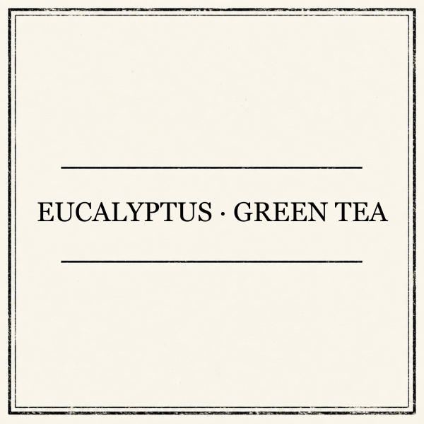 A square kraft-paper style label or packaging card with a distressed border and the centered text 'EUCALYPTUS • GREEN TEA' in black serif lettering.